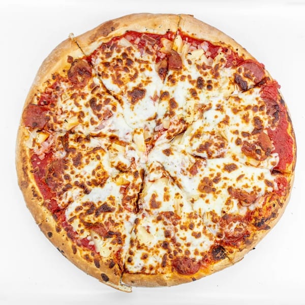 A whole Mangiamo La Pizza pepperoni and pineapple pizza, sliced, on a white background.