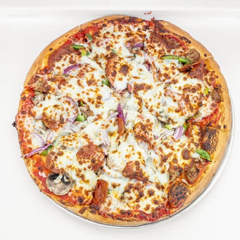 Mangiamo La Pizza's supreme pizza, topped with pepperoni, sausage, mushrooms, onions, and peppers.